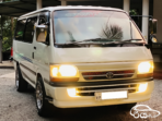 Dark gray front radiator grille for Toyota HiAce 1993-1994 Toyota HiAce H100 central diamond-mesh front grille insert Integrated chrome Toyota emblem badge on replacement grille Molded plastic upper front nose panel for 1993 HiAce van Toyota HiAce LH172 front bumper radiator grille TY04-0811A