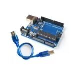 Arduino UNO R3 ATmega328P development board top view Microcontroller board for robotics and DIY coding projects Arduino UNO Rev3 featuring clearly printed header pins Close up of the ATmega328P chip on the development board Arduino UNO R3 development board setup with included USB cable
